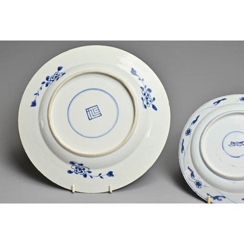 21 - TWO CHINESE BLUE AND WHITE PORCELAIN DISHES, KANGXI PERIOD. Each decorated with various floral scene... 