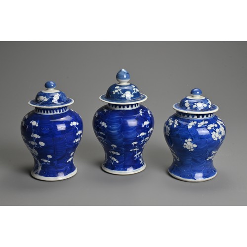 62 - THREE CHINESE BLUE AND WHITE PRUNUS JARS AND COVERS, 19/20TH CENTURY. Each of baluster form with dom... 