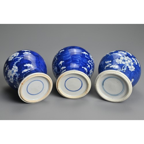 62 - THREE CHINESE BLUE AND WHITE PRUNUS JARS AND COVERS, 19/20TH CENTURY. Each of baluster form with dom... 