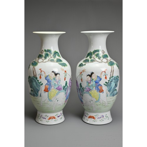 89 - A MIRRORED PAIR OF CHINESE FAMILLE ROSE PORCELAIN VASES, 20TH CENTURY. Decorated with children sat o... 