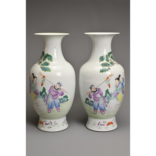 89 - A MIRRORED PAIR OF CHINESE FAMILLE ROSE PORCELAIN VASES, 20TH CENTURY. Decorated with children sat o... 