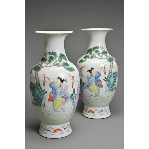 89 - A MIRRORED PAIR OF CHINESE FAMILLE ROSE PORCELAIN VASES, 20TH CENTURY. Decorated with children sat o... 