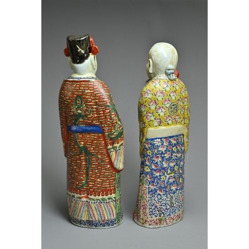 91 - TWO CHINESE POLYCHROME DECORATED PORCELAIN FIGURES, 20TH CENTURY. The Gods of fortune deities dresse... 