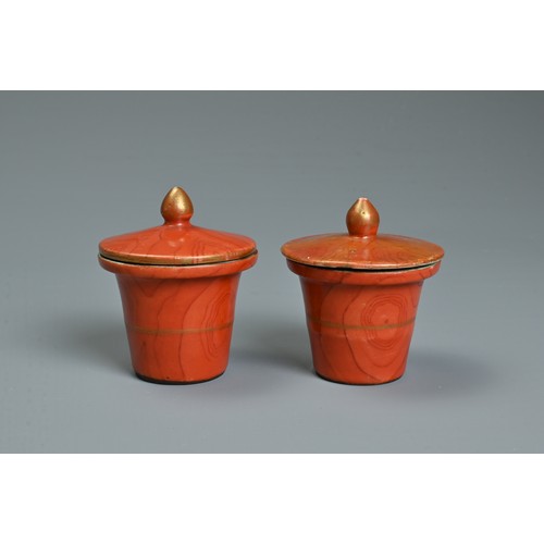 48 - TWO CHINESE CORAL GROUND FAUX BOIS PORCELAIN POTS AND COVERS, 19TH CENTURY. Painted to the exterior ... 