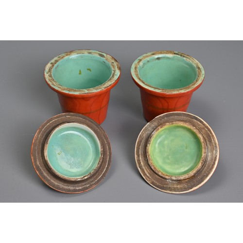 48 - TWO CHINESE CORAL GROUND FAUX BOIS PORCELAIN POTS AND COVERS, 19TH CENTURY. Painted to the exterior ... 