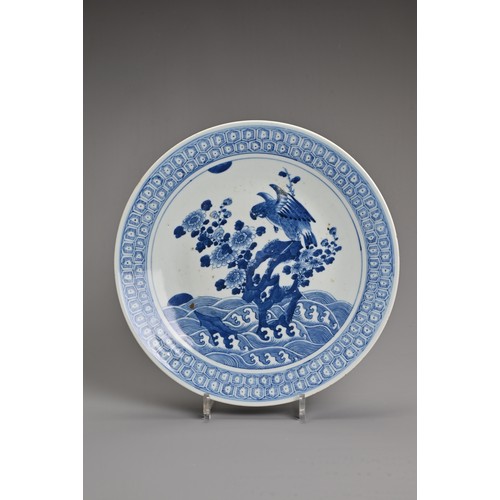 56 - A CHINESE BLUE AND WHITE PORCELAIN DISH, 19TH CENTURY. Decorated with an eagle and flowers on rockwo... 