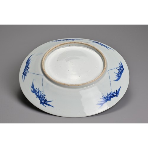 56 - A CHINESE BLUE AND WHITE PORCELAIN DISH, 19TH CENTURY. Decorated with an eagle and flowers on rockwo... 