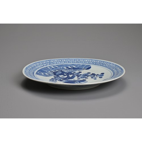 56 - A CHINESE BLUE AND WHITE PORCELAIN DISH, 19TH CENTURY. Decorated with an eagle and flowers on rockwo... 