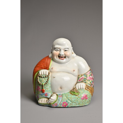 229 - A CHINESE FAMILLE ROSE PORCELAIN FIGURE OF BUDAI, MID 20TH CENTURY. The laughing Buddha seated dress... 