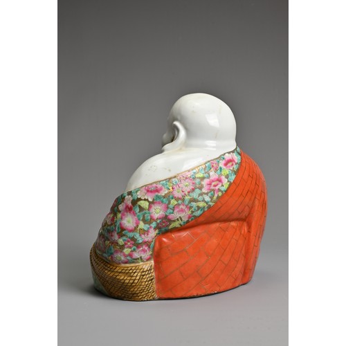 229 - A CHINESE FAMILLE ROSE PORCELAIN FIGURE OF BUDAI, MID 20TH CENTURY. The laughing Buddha seated dress... 