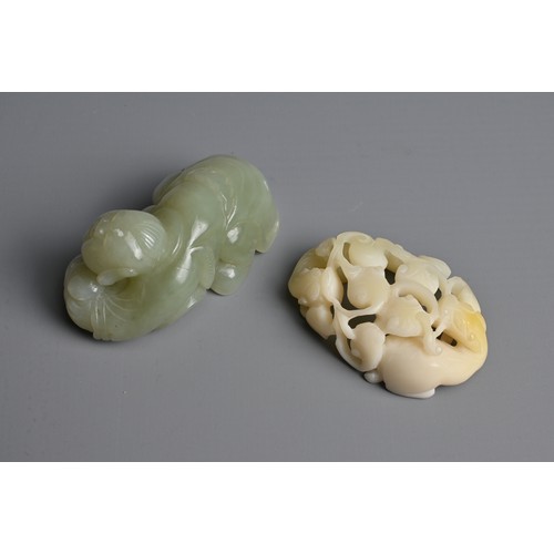 107 - TWO CHINESE JADE AND STONE CARVINGS. To include a pale celadon nephrite jade figure of a boy crouche... 