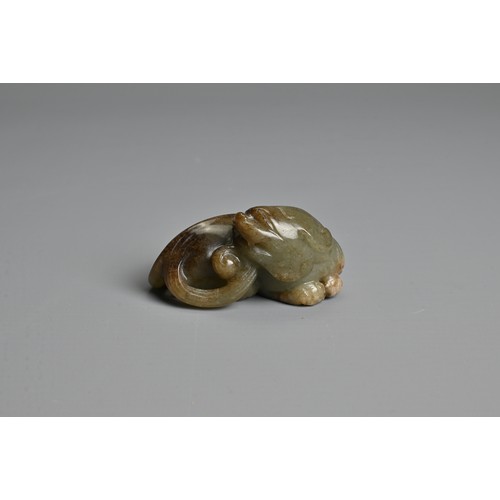 108 - A CHINESE CELADON AND BROWN JADE CARVING OF A BUDDHIST LION, QING DYNASTY. The nephrite jade figure ... 