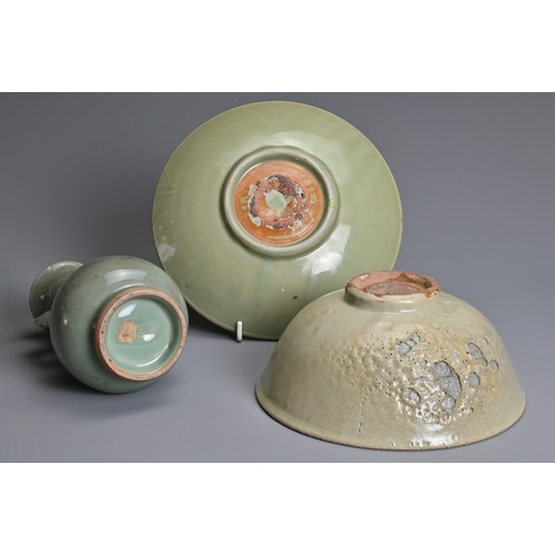 120 - THREE CHINESE CELADON PORCELAIN ITEMS, MING DYNASTY AND LATER. To include a Longquan celadon dish de... 