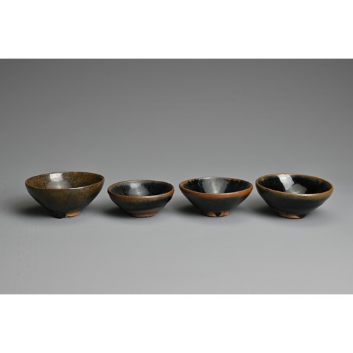 123 - FOUR CHINESE BLACK GLAZED POTTERY TEA BOWLS. Of varying sizes to include a hare's fur glazed bowl wi... 