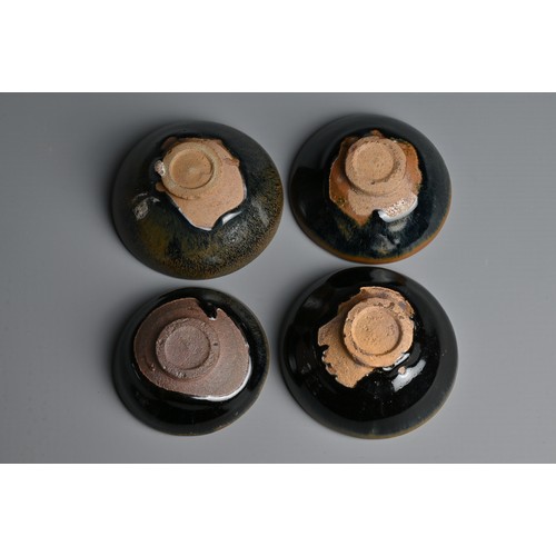 123 - FOUR CHINESE BLACK GLAZED POTTERY TEA BOWLS. Of varying sizes to include a hare's fur glazed bowl wi... 