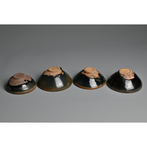 123 - FOUR CHINESE BLACK GLAZED POTTERY TEA BOWLS. Of varying sizes to include a hare's fur glazed bowl wi... 