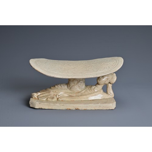 124 - A CHINESE SONG DYNASTY STYLE WHITE GLAZED PILLOW, with a recumbent lady base and incised floral deco... 