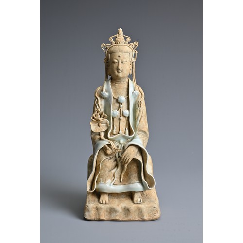 118 - A CHINESE SONG DYNASTY STYLE FIGURE OF GUANYIN, with qingbai glaze, in seated position holding a lot... 