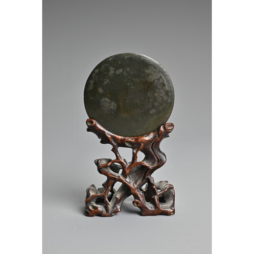 163 - A CHINESE BRONZE MIRROR ON WOODEN STAND, TANG DYNASTY (618–907). Circular form with animal form fini... 