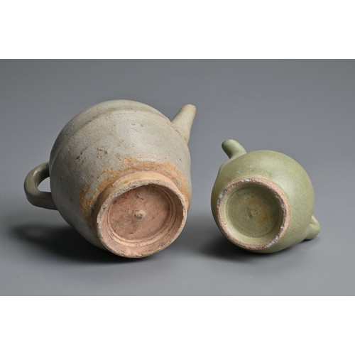 162 - TWO CHINESE GLAZED POTTERY EWERS, YUAN / MING DYNASTY. The larger ewer covered in a greyish glaze an... 