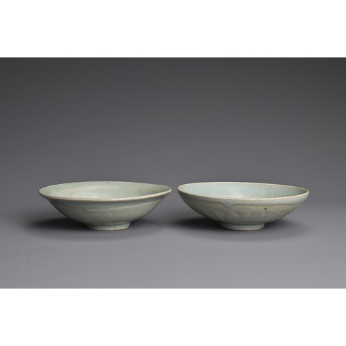 145 - TWO CHINESE QINGBAI WARE PORCELAIN BOWLS, YUAN DYNASTY (1279-1368). Each thickly potted with carved ... 