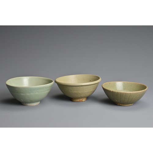 144 - THREE CHINESE CELADON GLAZED BOWLS, YUAN / MING DYNASTY. Each thickly potted with varying designs. 1... 