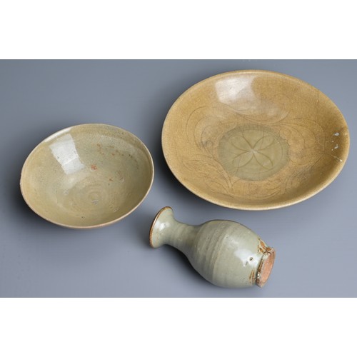 139 - THREE CHINESE CELADON GLAZED PORCELAIN ITEMS, SONG TO MING DYNASTY. To include a thickly potted shal... 