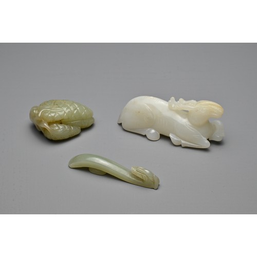 71 - THREE CHINESE CARVED JADE ITEMS. To include a white jade model of a recumbent deer; A small celadon ... 