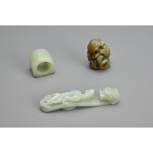 74 - THREE CHINESE CARVED JADE ITEMS. To include pale celadon openwork chilong and dragon head belt hook;... 