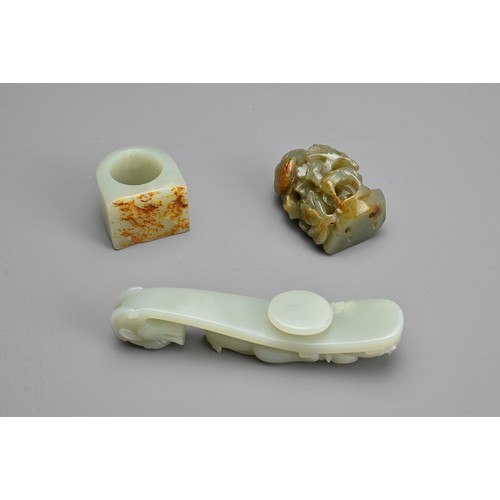 74 - THREE CHINESE CARVED JADE ITEMS. To include pale celadon openwork chilong and dragon head belt hook;... 