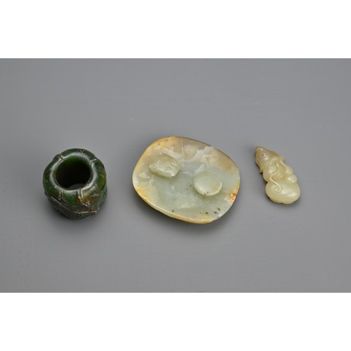 75 - THREE CHINESE CARVED JADE ITEMS. To include a celadon jade belt plaque carved in relief with figure ... 