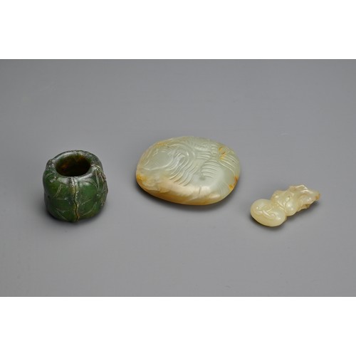 75 - THREE CHINESE CARVED JADE ITEMS. To include a celadon jade belt plaque carved in relief with figure ... 