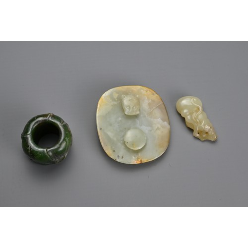 75 - THREE CHINESE CARVED JADE ITEMS. To include a celadon jade belt plaque carved in relief with figure ... 