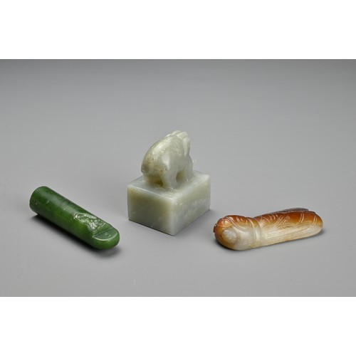 77 - THREE CHINESE CARVED JADE ITEMS. To include a square seal surmounted by an elephant and incised four... 