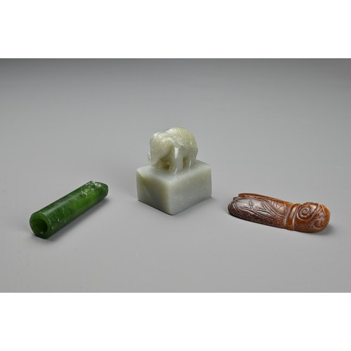 77 - THREE CHINESE CARVED JADE ITEMS. To include a square seal surmounted by an elephant and incised four... 