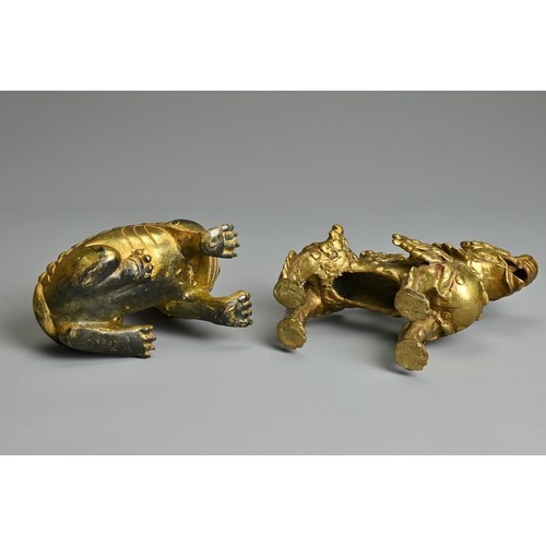 180 - A CHINESE GILT-BRONZE MODEL OF A SEATED LION, A GILT-METAL LION, PROBABLY TIBETAN AND TWO SEALS, the... 