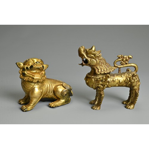 180 - A CHINESE GILT-BRONZE MODEL OF A SEATED LION, A GILT-METAL LION, PROBABLY TIBETAN AND TWO SEALS, the... 