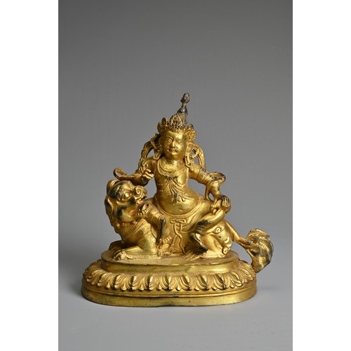 181 - A SINO-TIBETAN GILT-BRONZE FIGURE OF VAISHRAVANA, cast seated atop a lion holding a rat in his left ... 