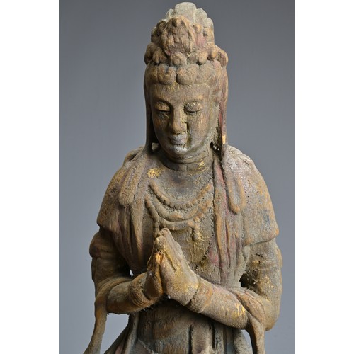 178 - A CHINESE OR SOUTH EAST ASIAN CARVED WOOD, COLD-PAINTED AND GILT FIGURE OF A SEATED BODHISATTVA OR G... 