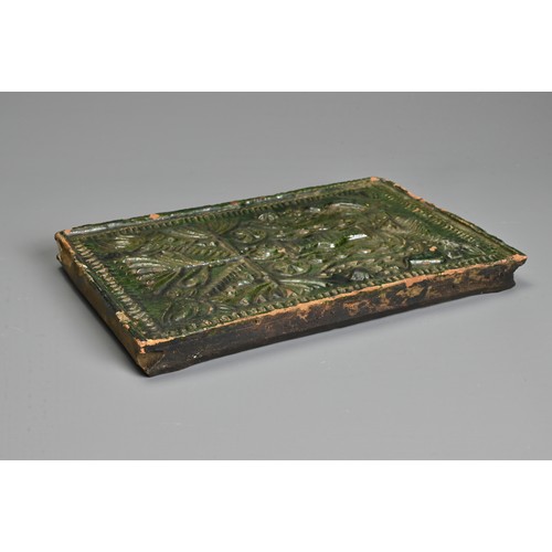 267 - A GREEN-GLAZED POTTERY STOVE TILE, PROBABLY GERMAN AND 16TH CENTURY OR LATER. Moulded with vase issu... 