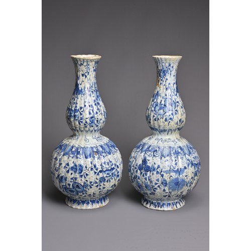 269 - A PAIR OF DUTCH DELFT BLUE AND WHITE FLUTED DOUBLE GOURD-SHAPED BOTTLE VASES AND A HEXAGONAL SECTION... 