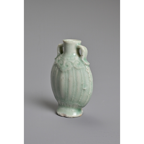 31 - A CHINESE PALE CELADON GLAZED MINIATURE PORCELAIN BOTTLE, 19TH CENTURY. Of flattened ovoid form with... 