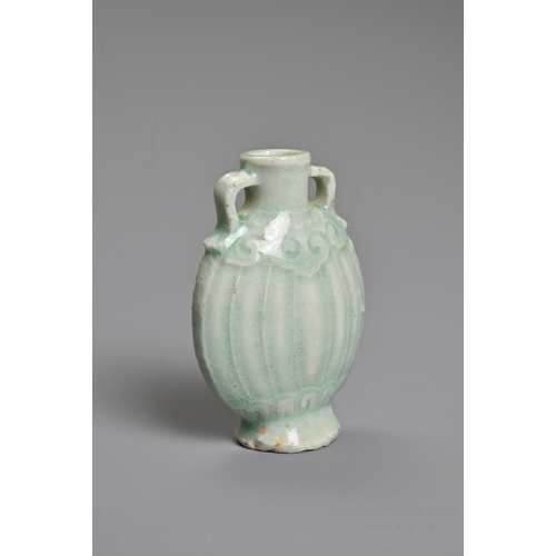 31 - A CHINESE PALE CELADON GLAZED MINIATURE PORCELAIN BOTTLE, 19TH CENTURY. Of flattened ovoid form with... 