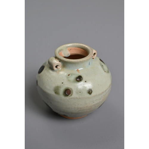 32 - A CHINESE SPOTTED GLAZED PORCELAIN JAR, YUAN DYNASTY. A small globular jar with two looped handles c... 