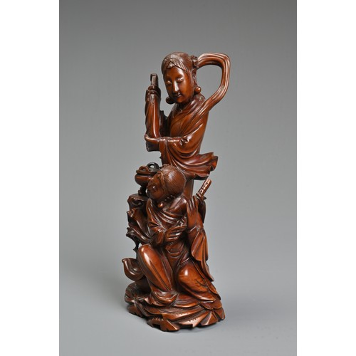 29 - A CHINESE CARVED BOXWOOD FIGURE OF GUANYIN. Well carved depicting figure of Guanyin next to a girl s... 