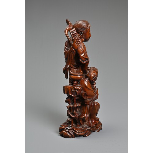 29 - A CHINESE CARVED BOXWOOD FIGURE OF GUANYIN. Well carved depicting figure of Guanyin next to a girl s... 