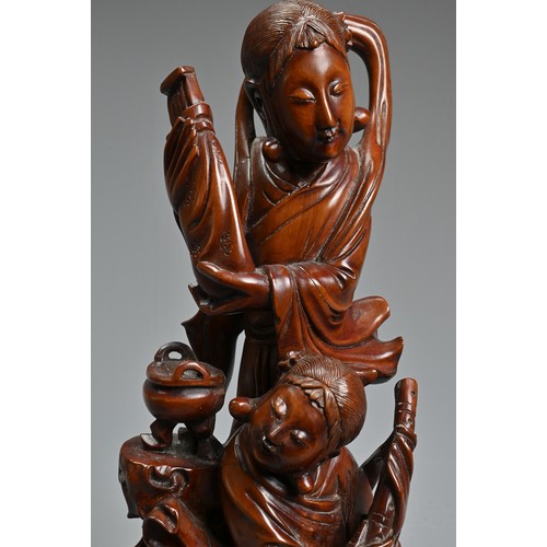 29 - A CHINESE CARVED BOXWOOD FIGURE OF GUANYIN. Well carved depicting figure of Guanyin next to a girl s... 