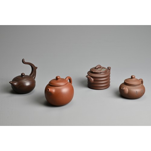 38 - FOUR CHINESE YIXING POTTERY TEAPOTS, 20TH CENTURY OR LATER. Of varying sizes and forms each with mak... 