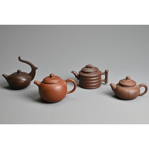 38 - FOUR CHINESE YIXING POTTERY TEAPOTS, 20TH CENTURY OR LATER. Of varying sizes and forms each with mak... 