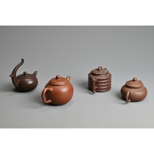 38 - FOUR CHINESE YIXING POTTERY TEAPOTS, 20TH CENTURY OR LATER. Of varying sizes and forms each with mak... 